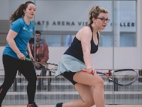 Two students playing squash