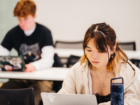 students working on laptops on desks