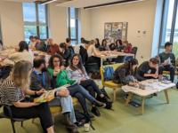 people in a room seated talking