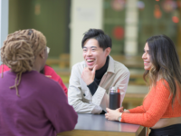 students around a table talking