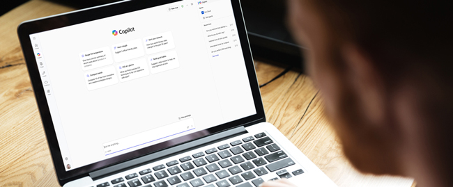 an image of a student looking at a laptop running Copilot