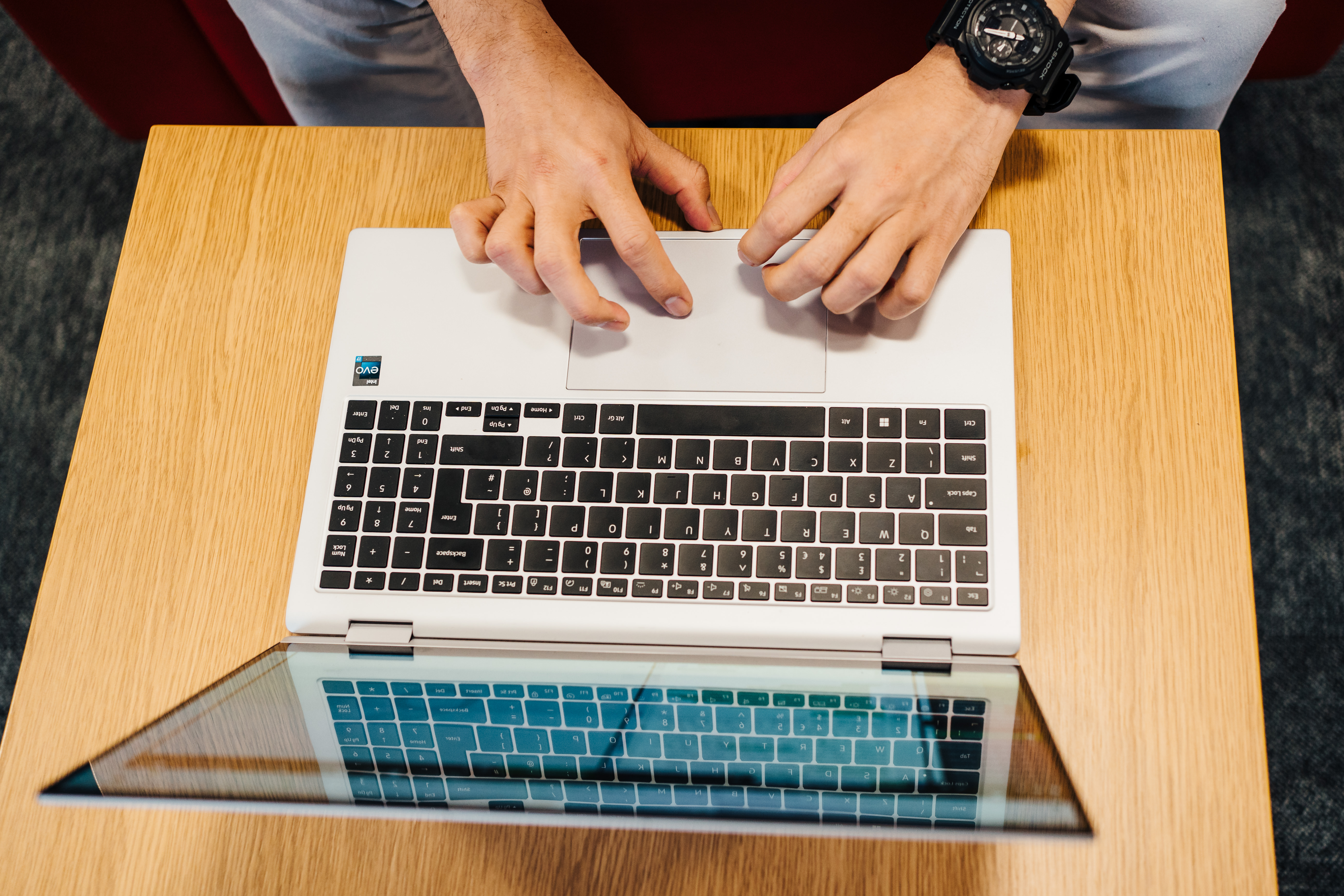 A person touching the mousepad of a laptop