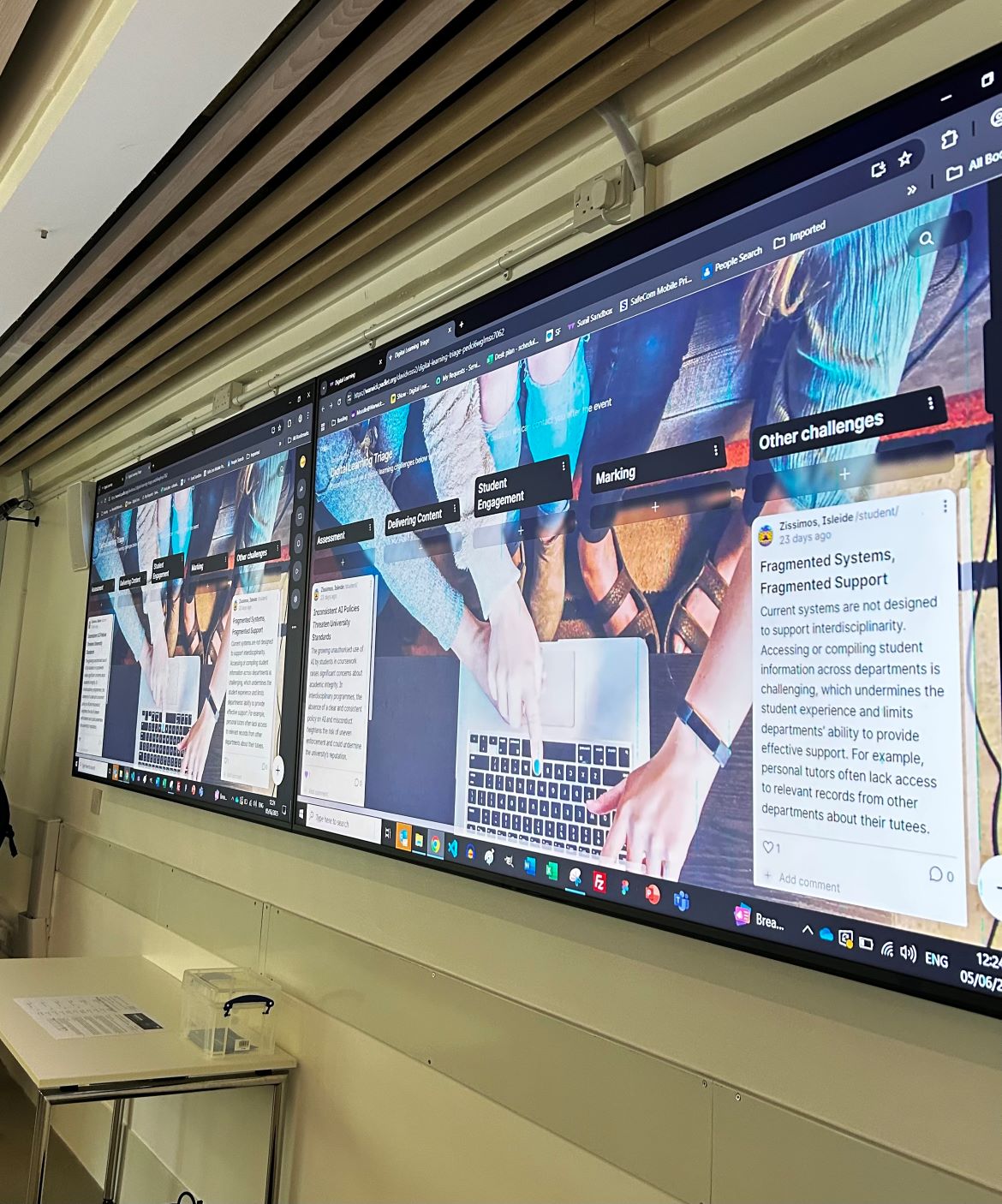 Two large screens with a padlet board for delegates to add on their digital learning challenges